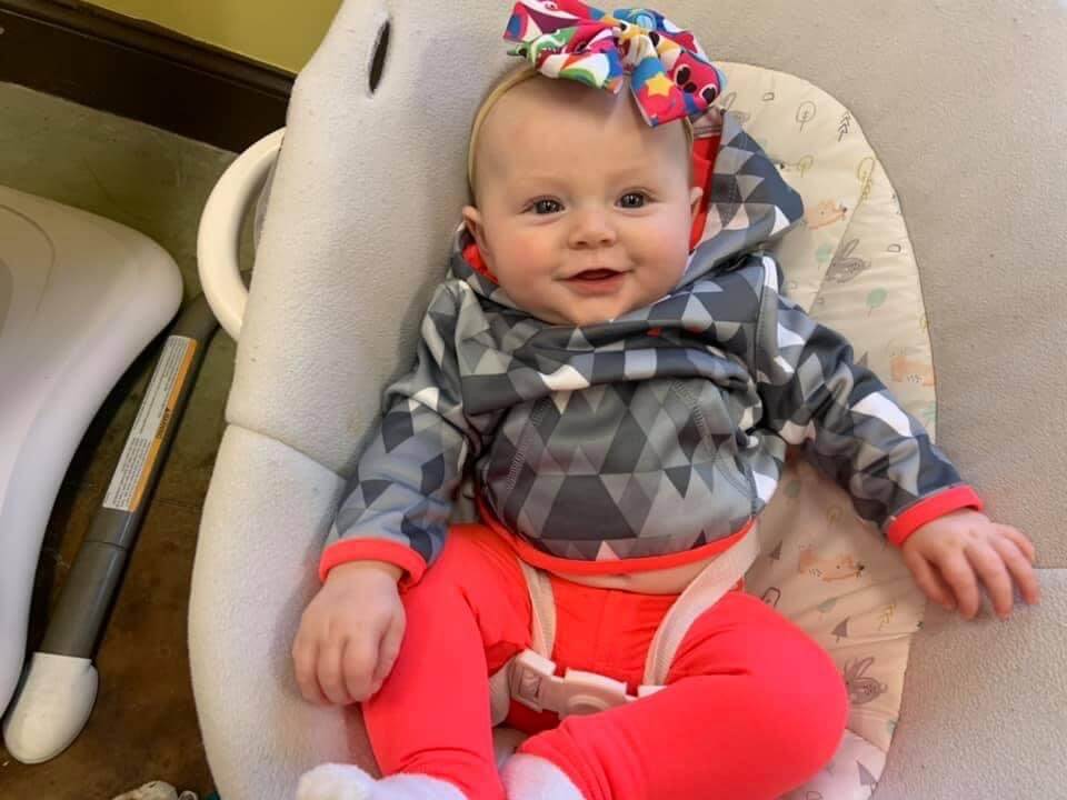 Black baby girl with pigtails laughing