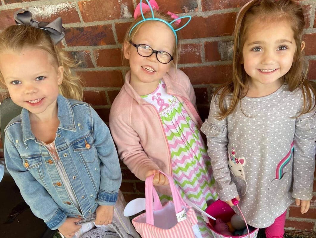 Four white girls with heart shirts smiling